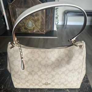 Gently used Beige and white  Authentic Coach purse. Small shoulder strap.